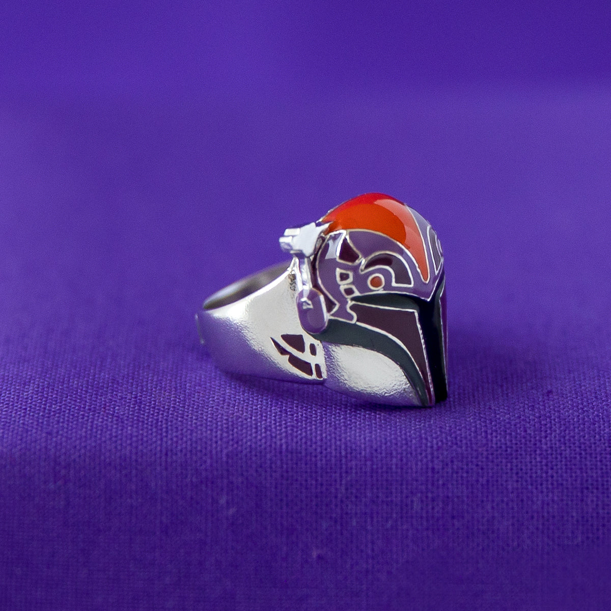 Detail of the orange, purple, and burgundy hand painted enamel.