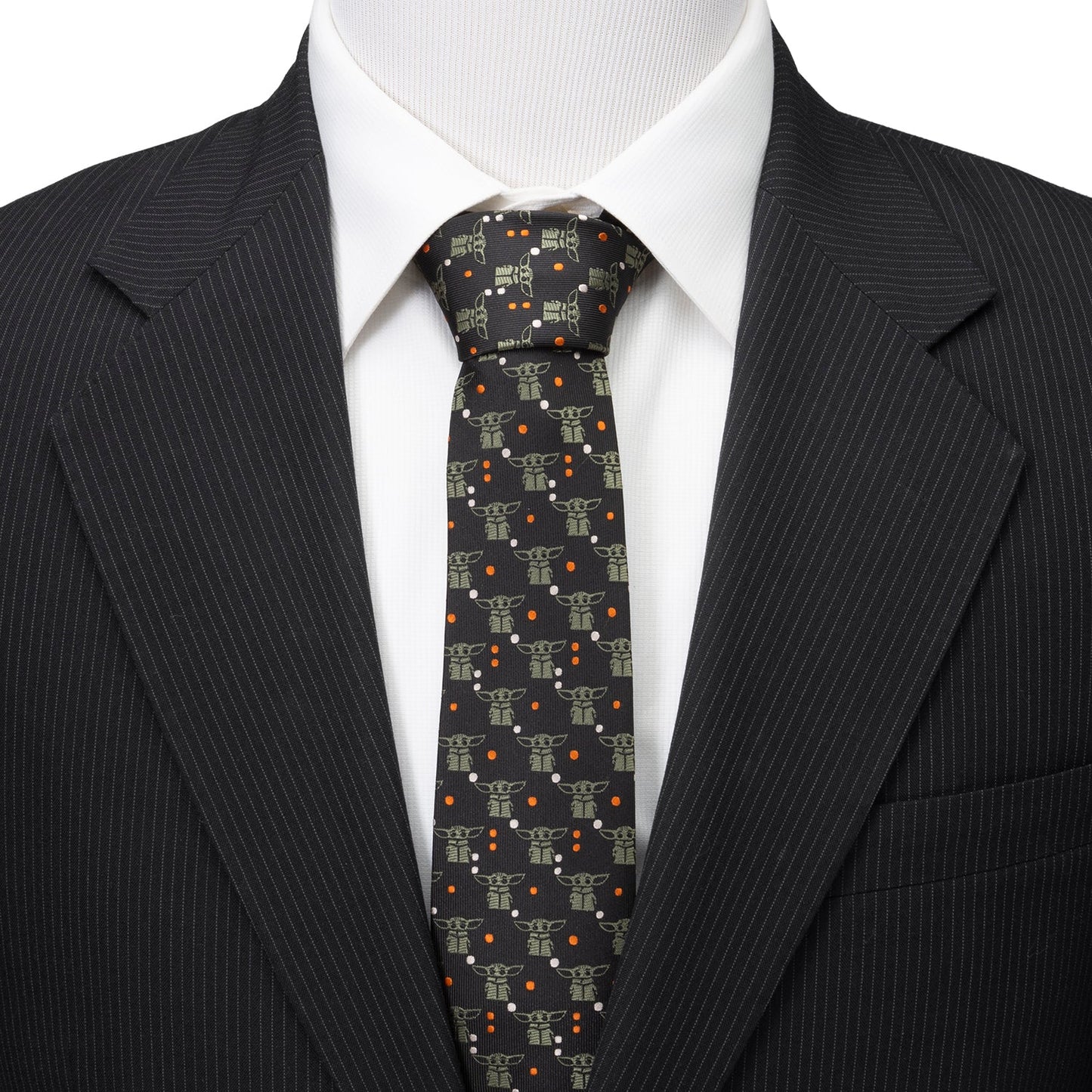Close-up of sage green Grogu motifs on black polyester tie