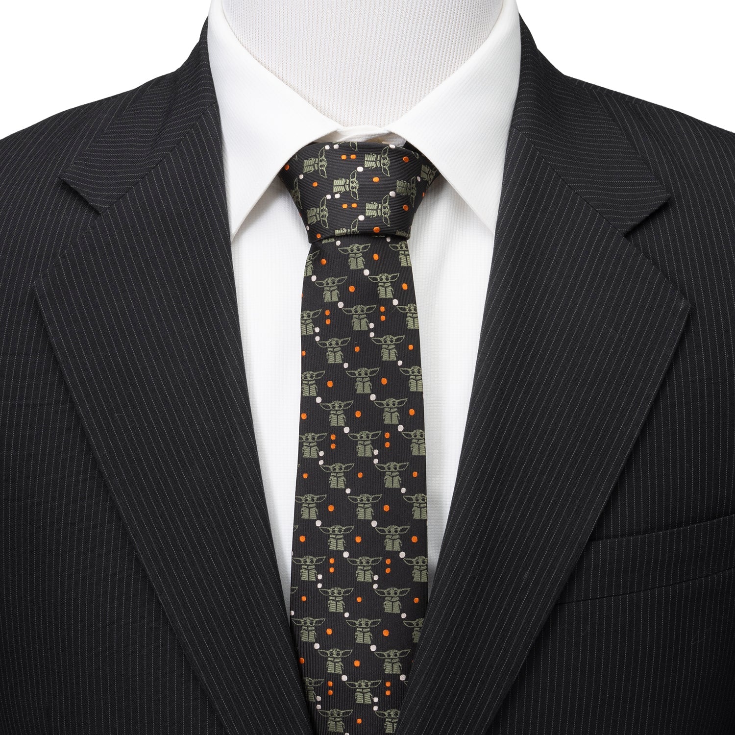 Close-up of sage green Grogu motifs on black polyester tie