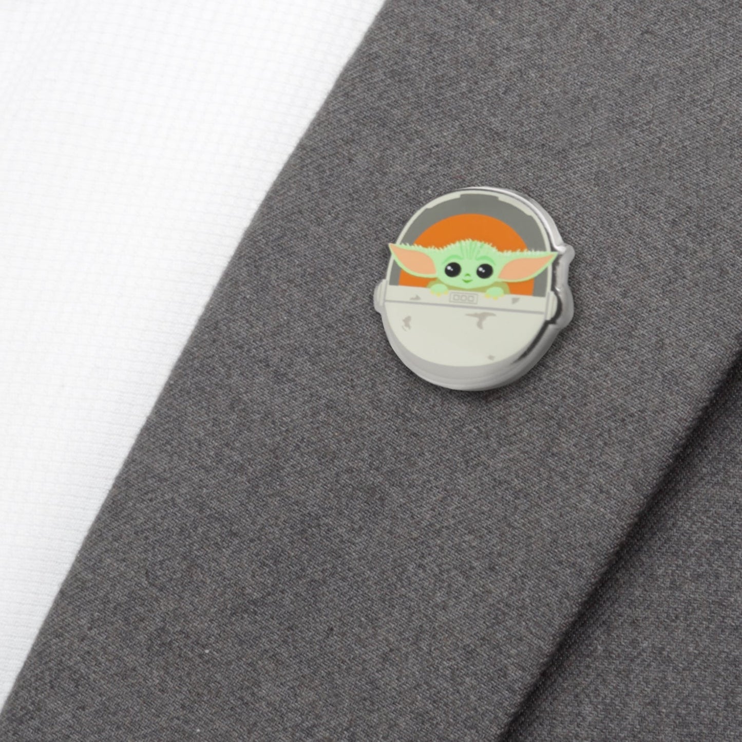 Grogu lapel pin on a denim jacket lapel