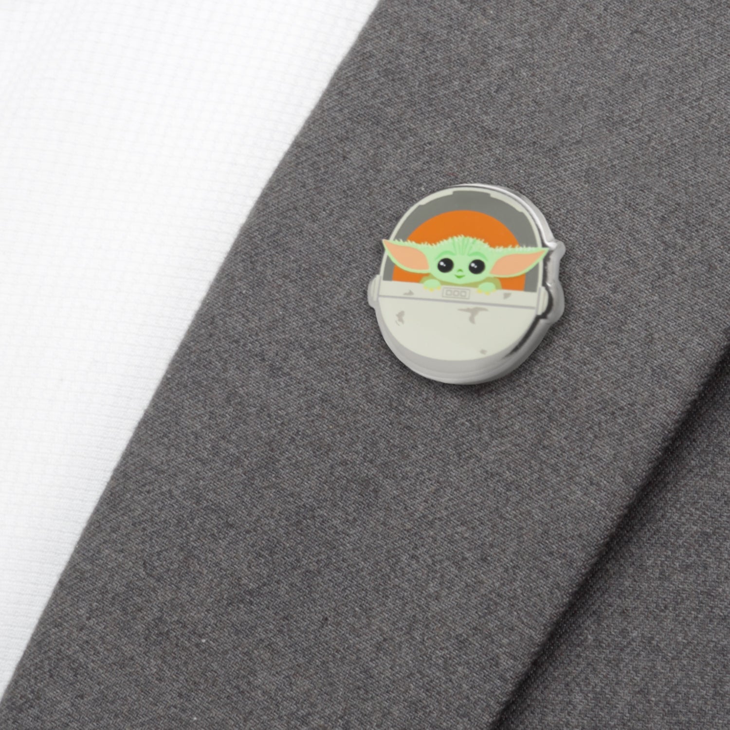 Grogu lapel pin on a denim jacket lapel
