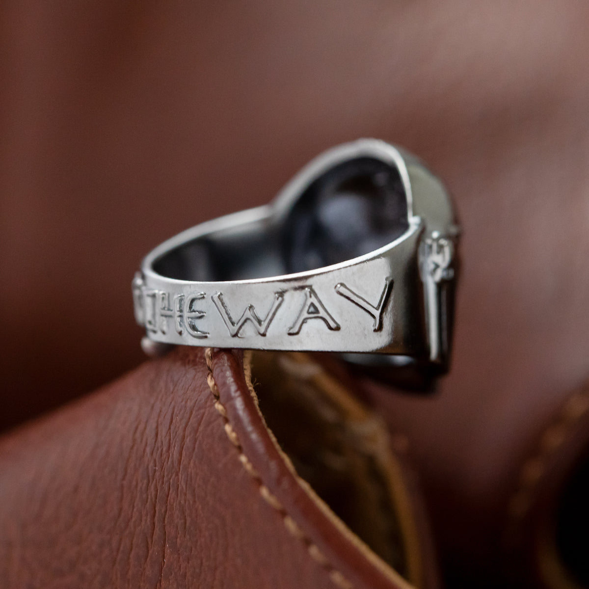 The Mandalorian Helmet Ring presented on a dark background for detail