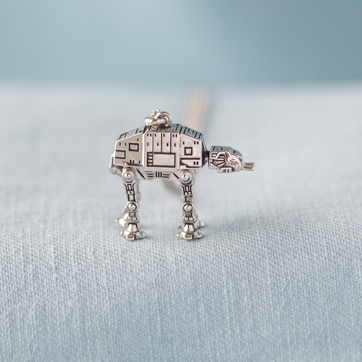 Side view showing detailed armored plating of AT-AT necklace