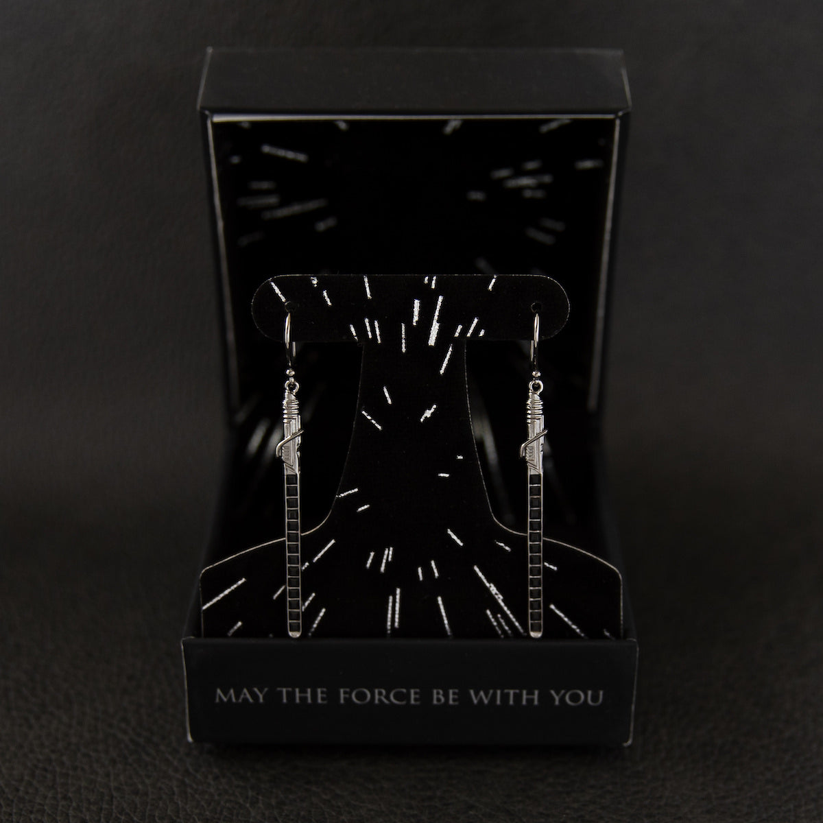 Full view of the black rhodium-plated Darksaber earrings inspired by The Mandalorian.