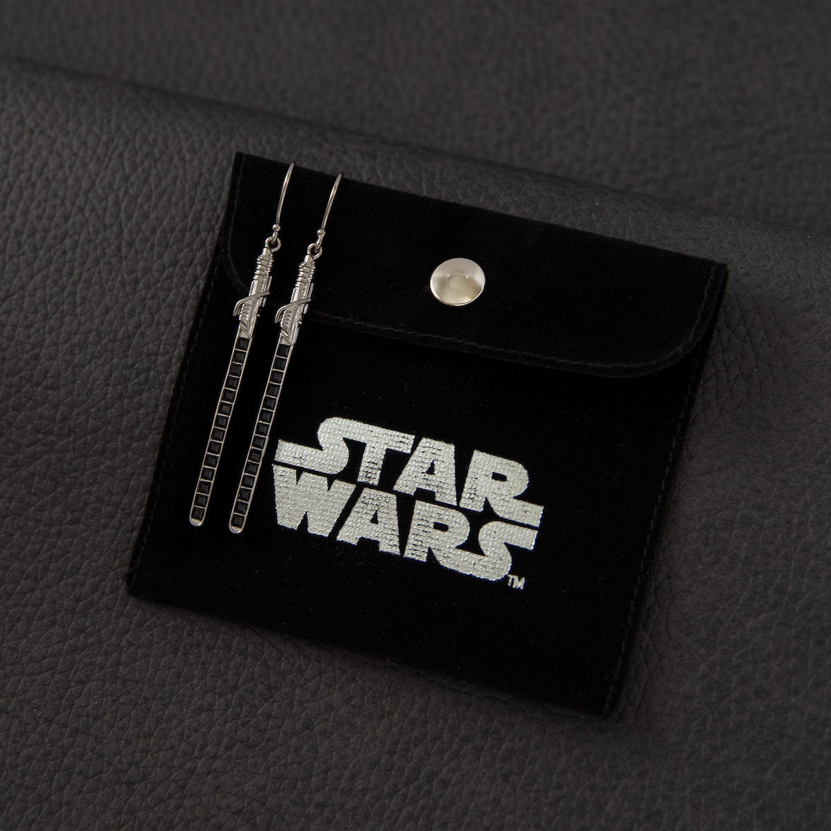 Side view of the slender 50mm Darksaber blade earrings by RockLove Jewelry.