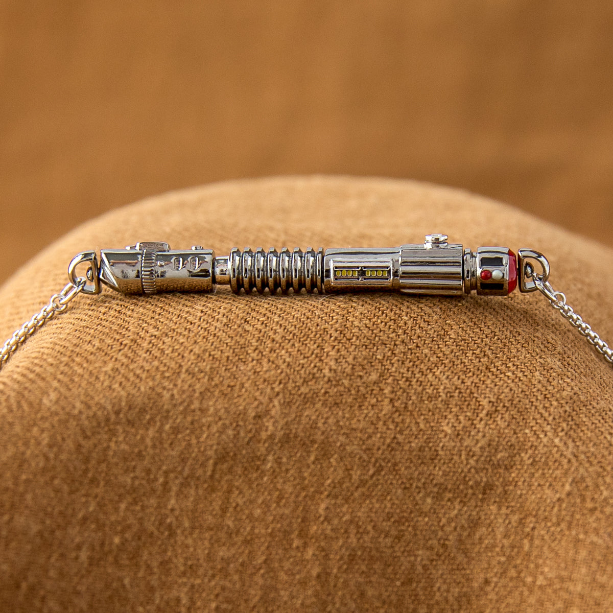 The fully assembled Star Wars Power and Control Lightsaber pendant hanging on a rounded box chain.