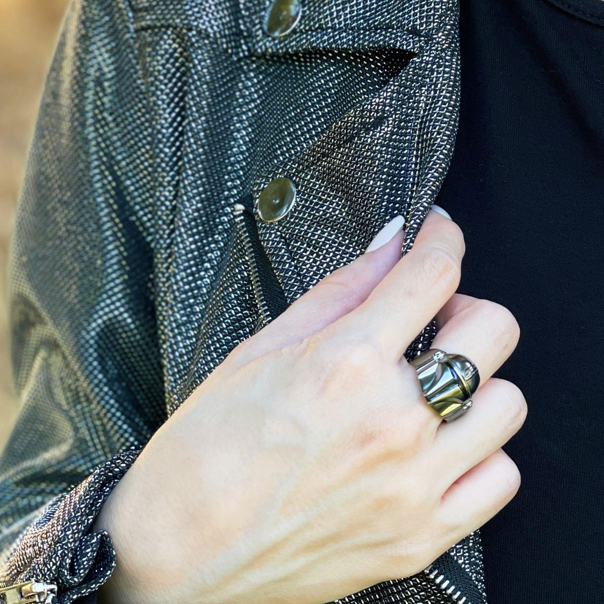 Lifestyle shot of the Mandalorian sterling silver ring on a finger