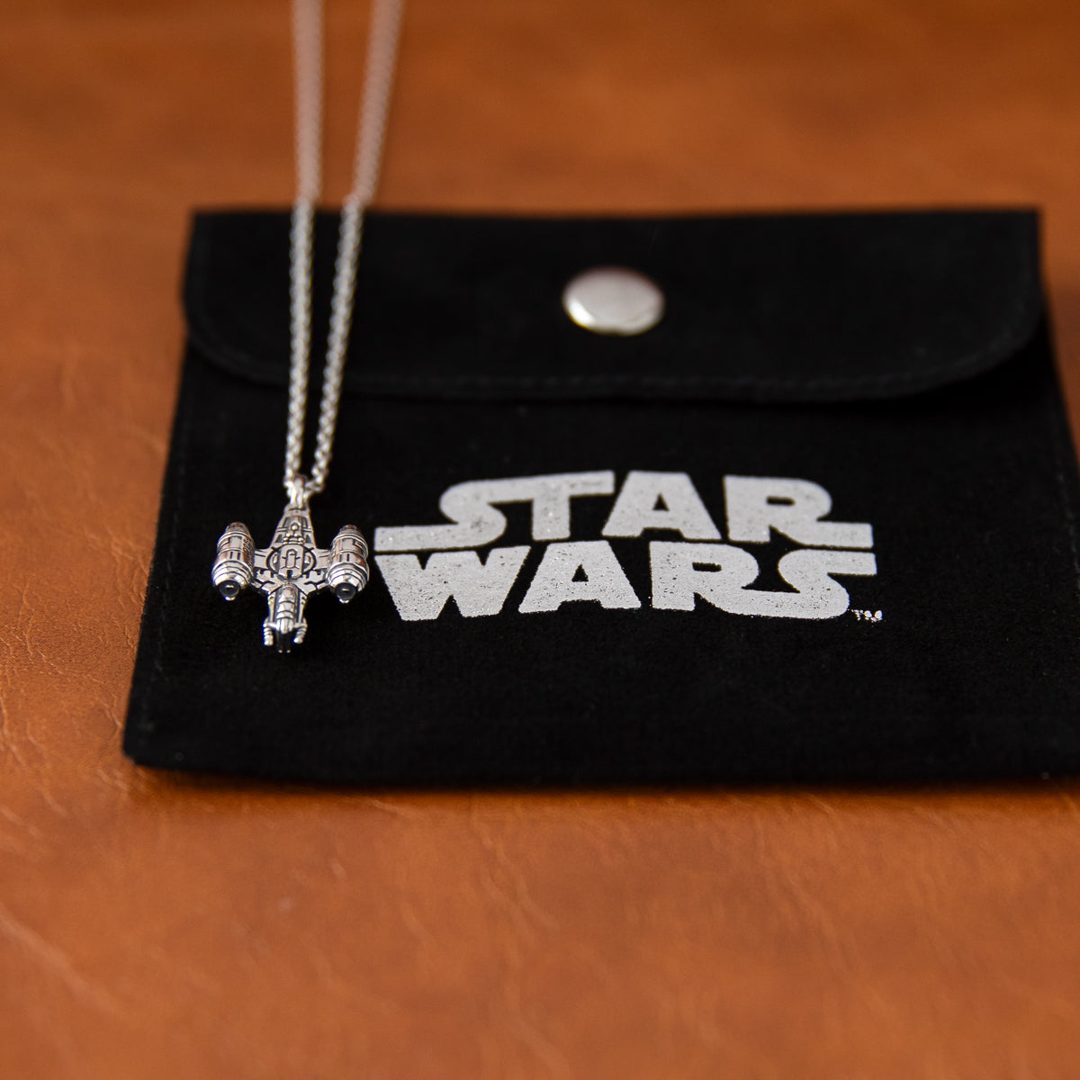 The Razor Crest jewelry piece showcasing intricate ship details