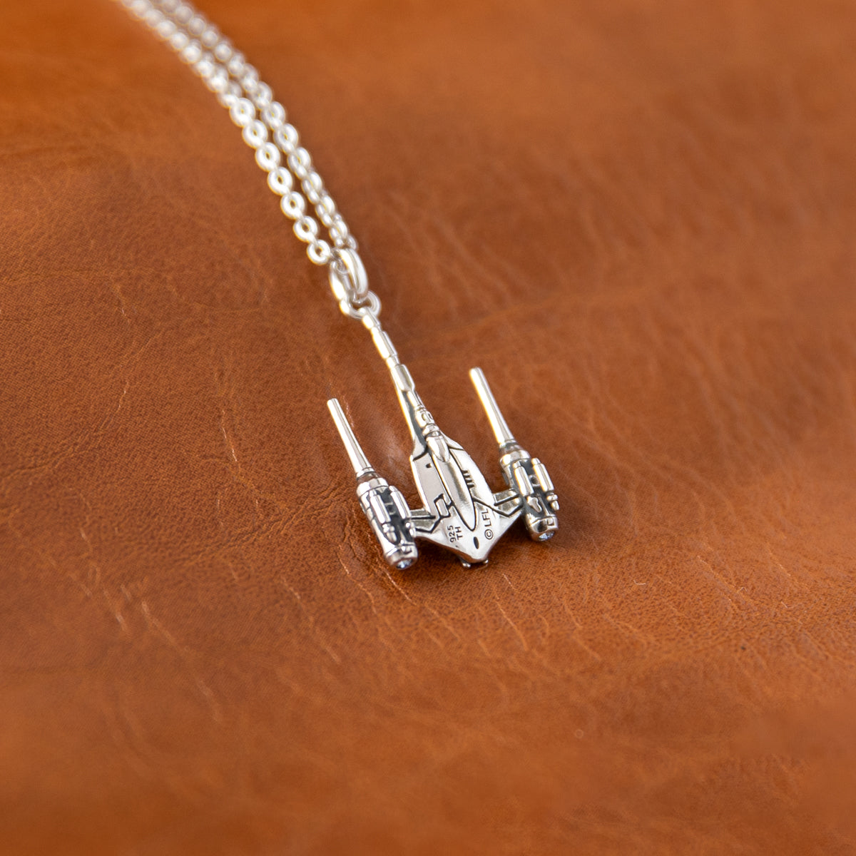 The Naboo N-1 Starfighter necklace displayed in its STAR WARS RockLove Collector's Box